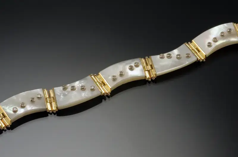 Mother of Pearl set in 18K Yellow Gold set with Diamonds